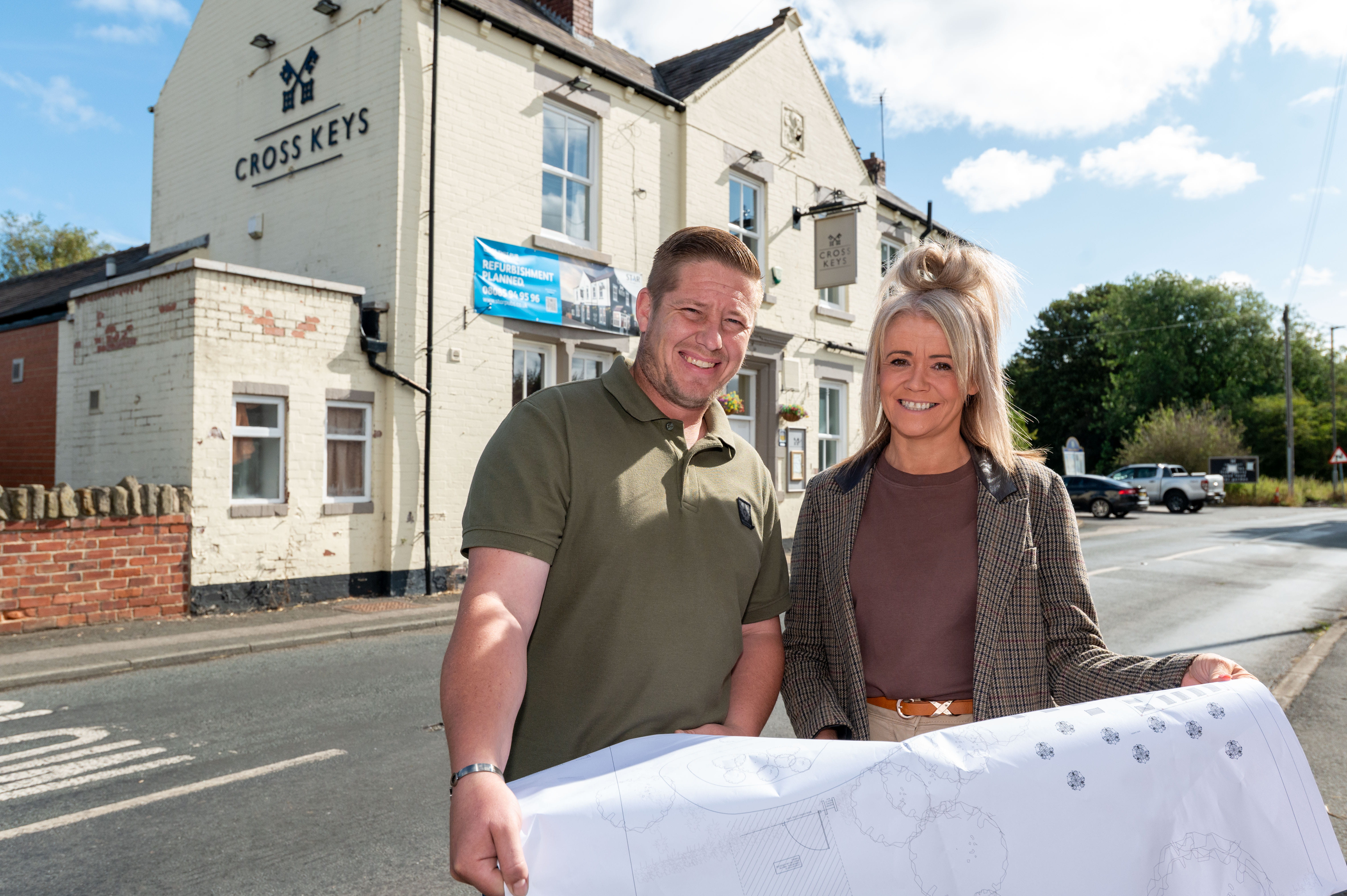 CROSS KEYS Pub in OLD SNYDALE with two operators stanidng outside holding blueprints