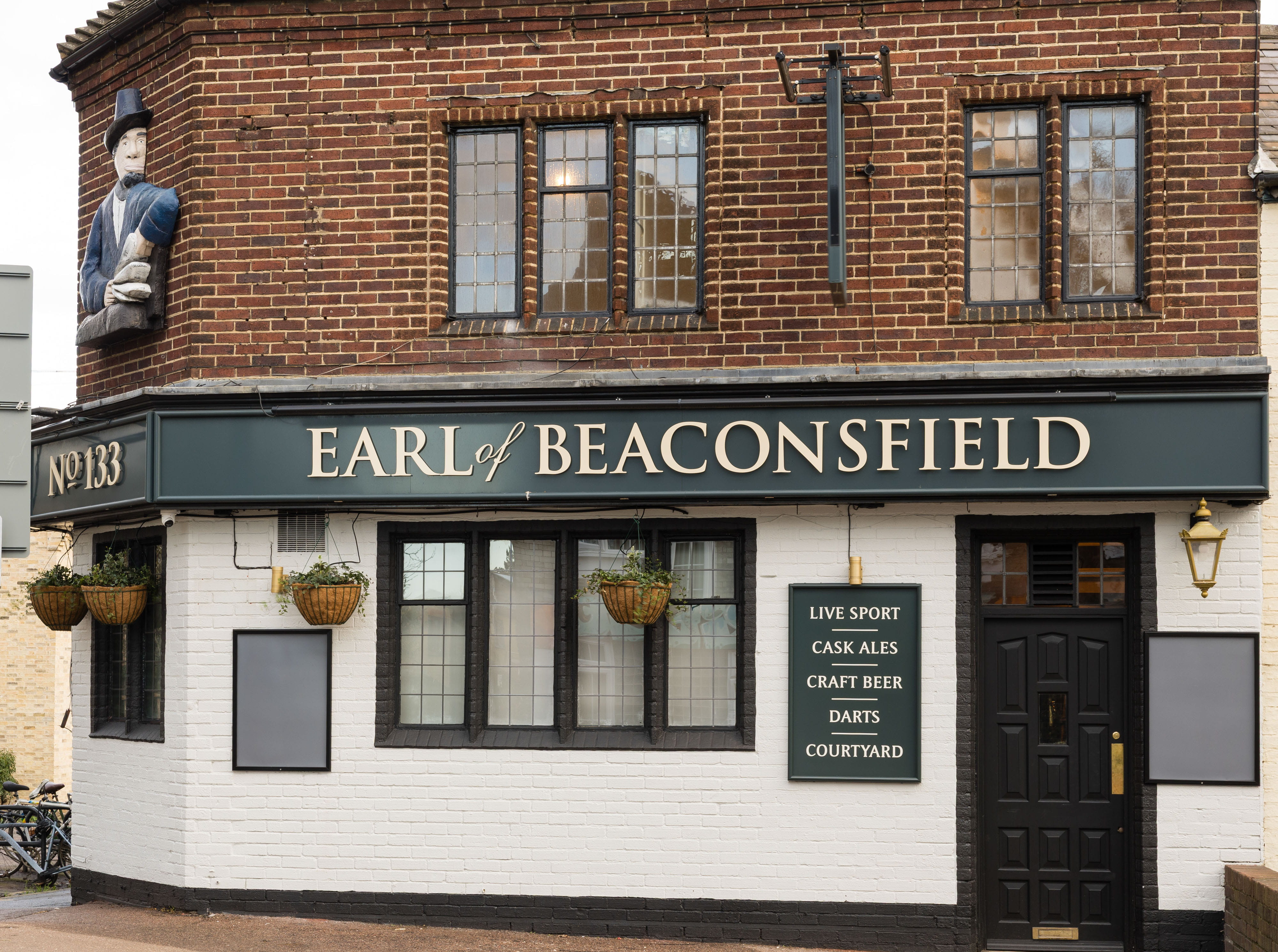 Exterior image of a pub with a sign that says 'Earl of Beaconsfield'