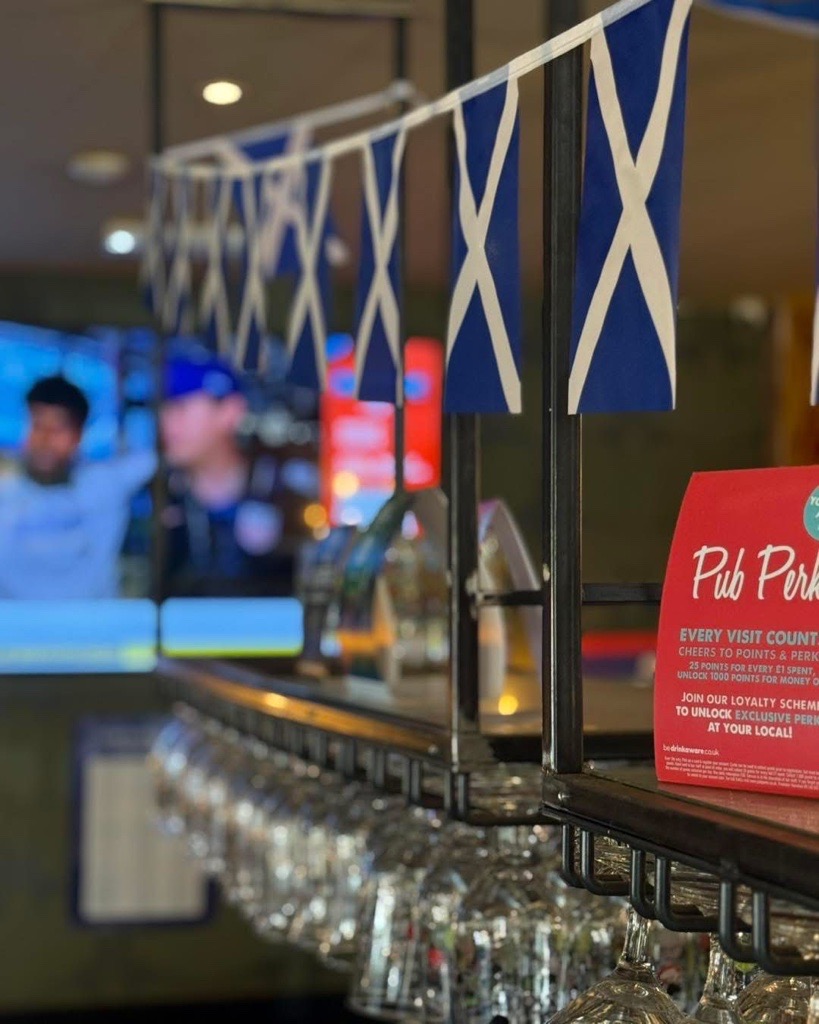 Pub interior with Scotland flag garland hanging above bar