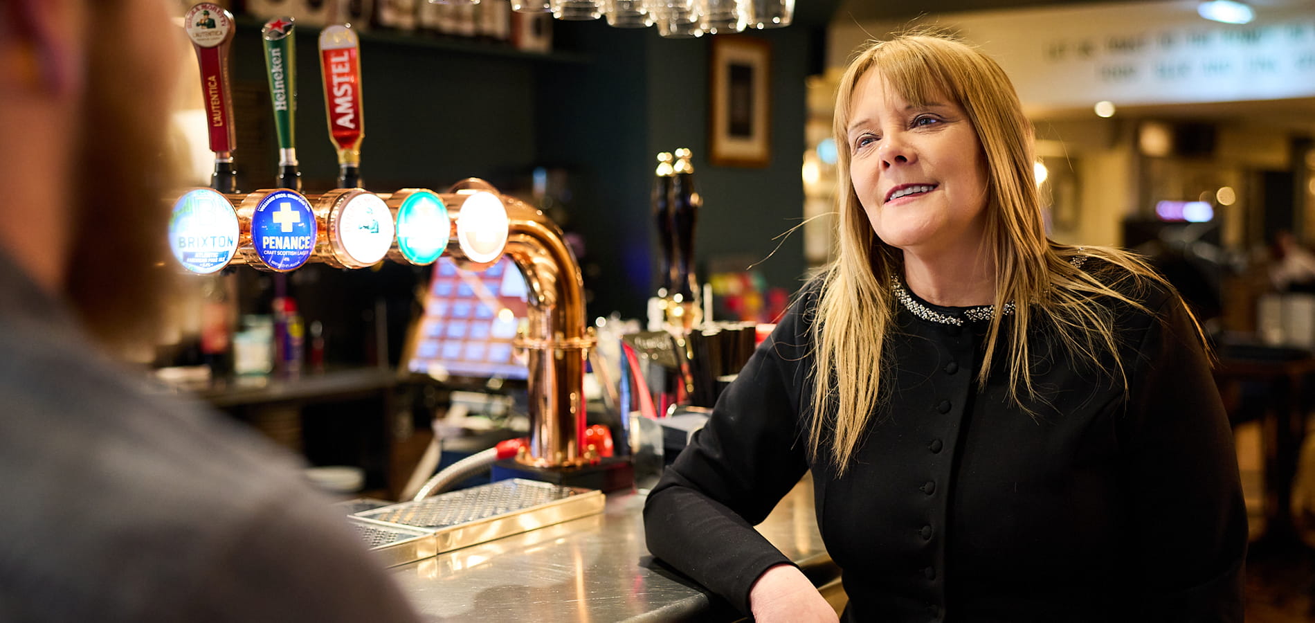 Woman discussing pub business plan at the bar