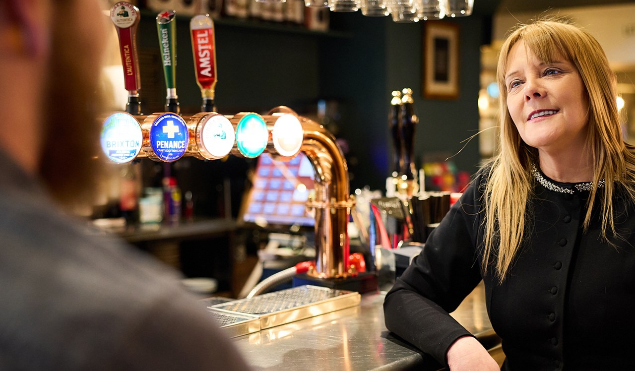 Woman discussing pub business plan at the bar