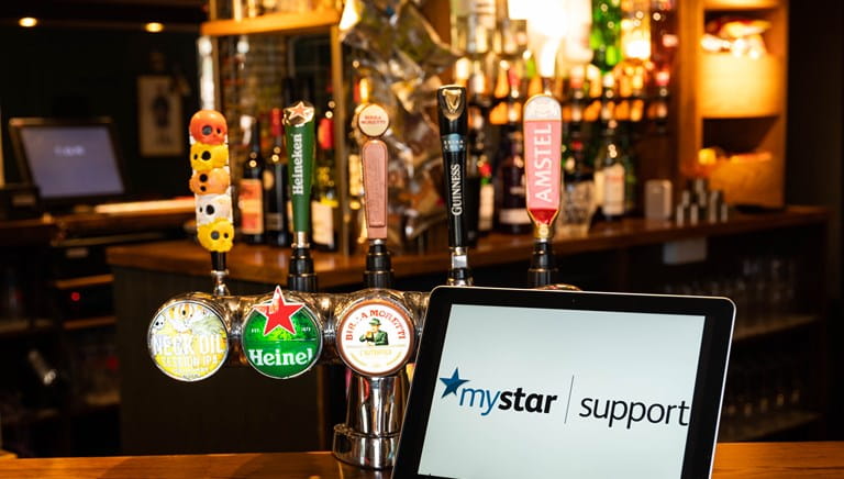 Laptop saying 'MyStar Support' sitting on a bar