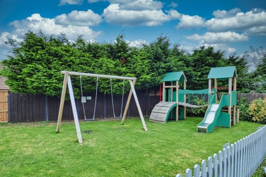 Children's play area with slides and swing set