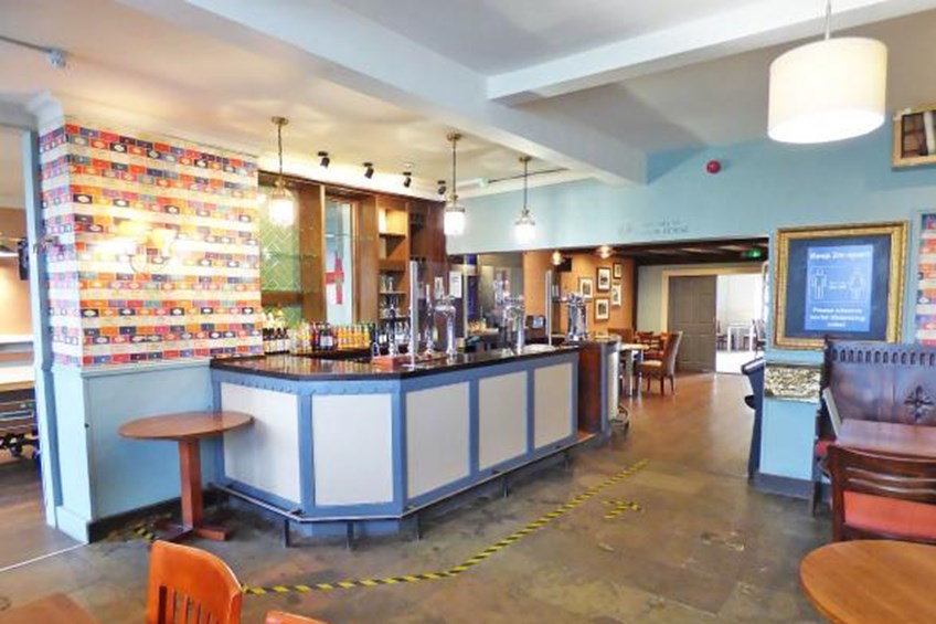 Main interior area with chairs, tables and bar