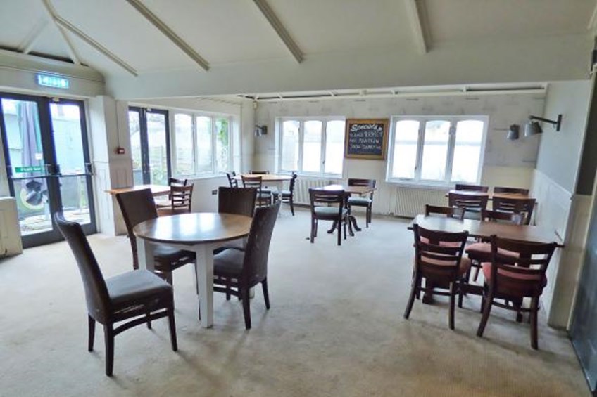 Dining area with tables, specials menu and access to garden area
