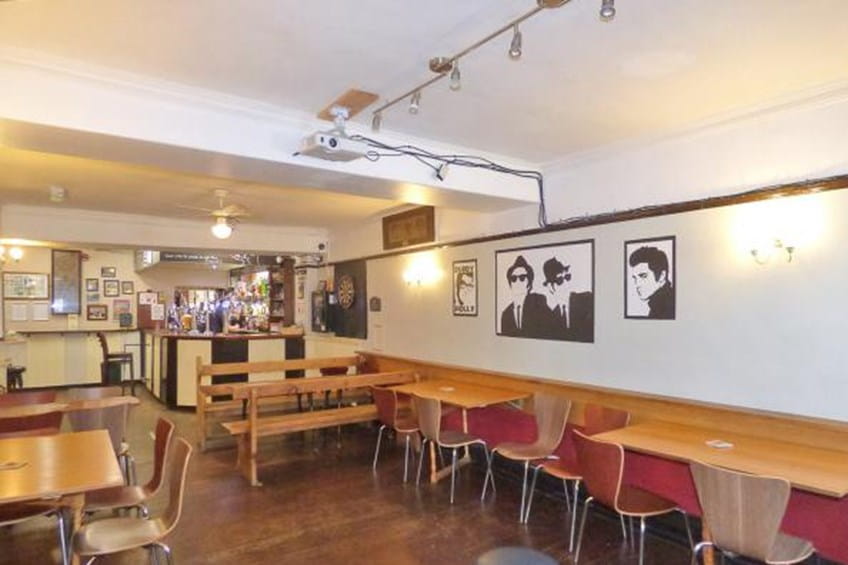 Seating area with tables, benches and dart board