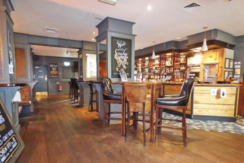 Main bar area with tables and leather chairs