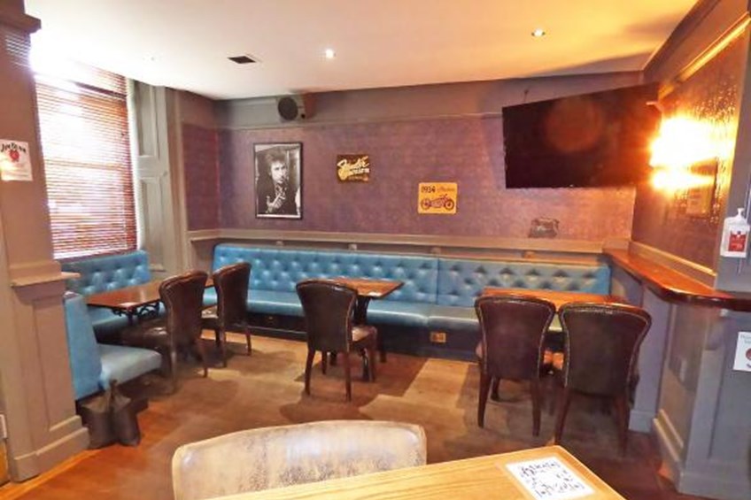 Sitting area with benches, chairs, table and TV