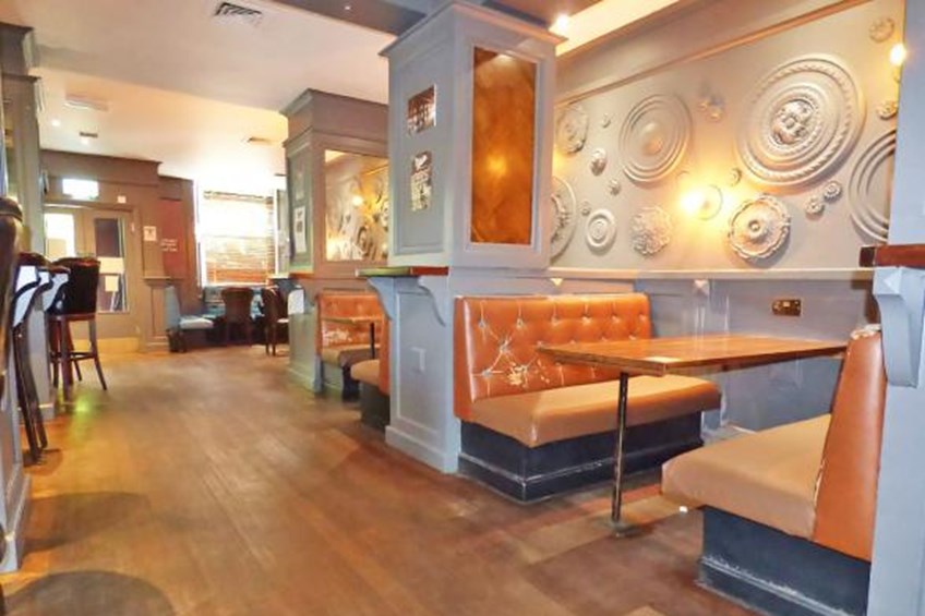 Sitting area with booths and mirrors